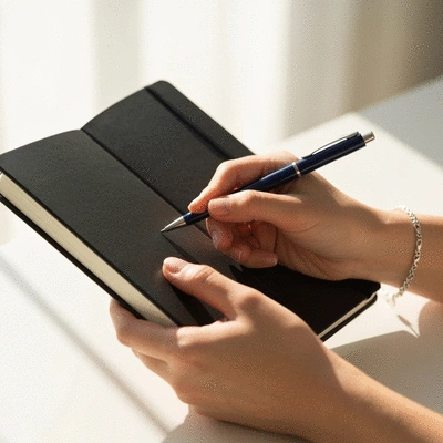 Person writing in a grief journal