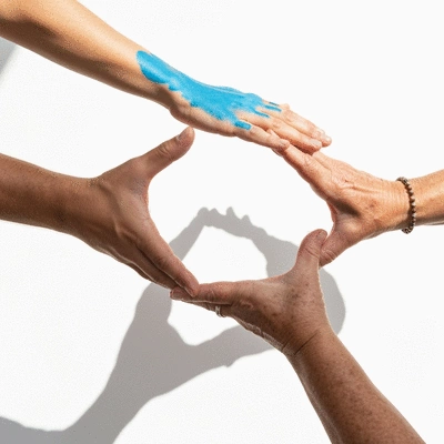 Diverse hands reaching out to form a circle, symbolizing human rights and unity