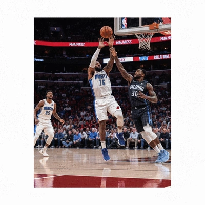 Basketball players in action during a game, representing Miami Heat vs Orlando Magic