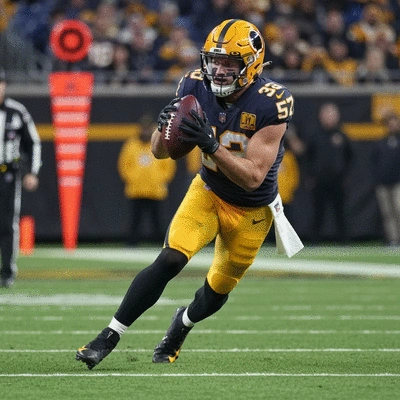 Zach Ertz in action, catching a pass during a Commanders game