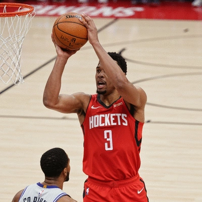 Eric Gordon in a Houston Rockets uniform, shooting a three-pointer during a game